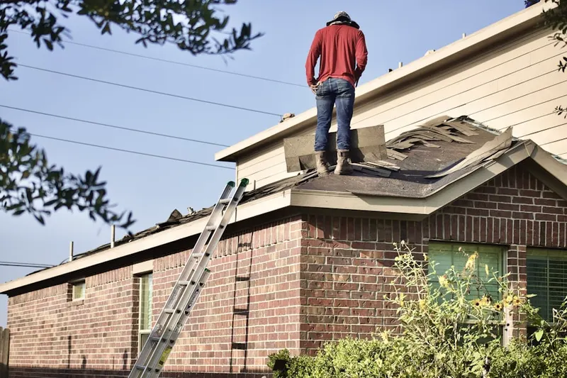 Professional roofer working on a residential roof in Del Haven Estates